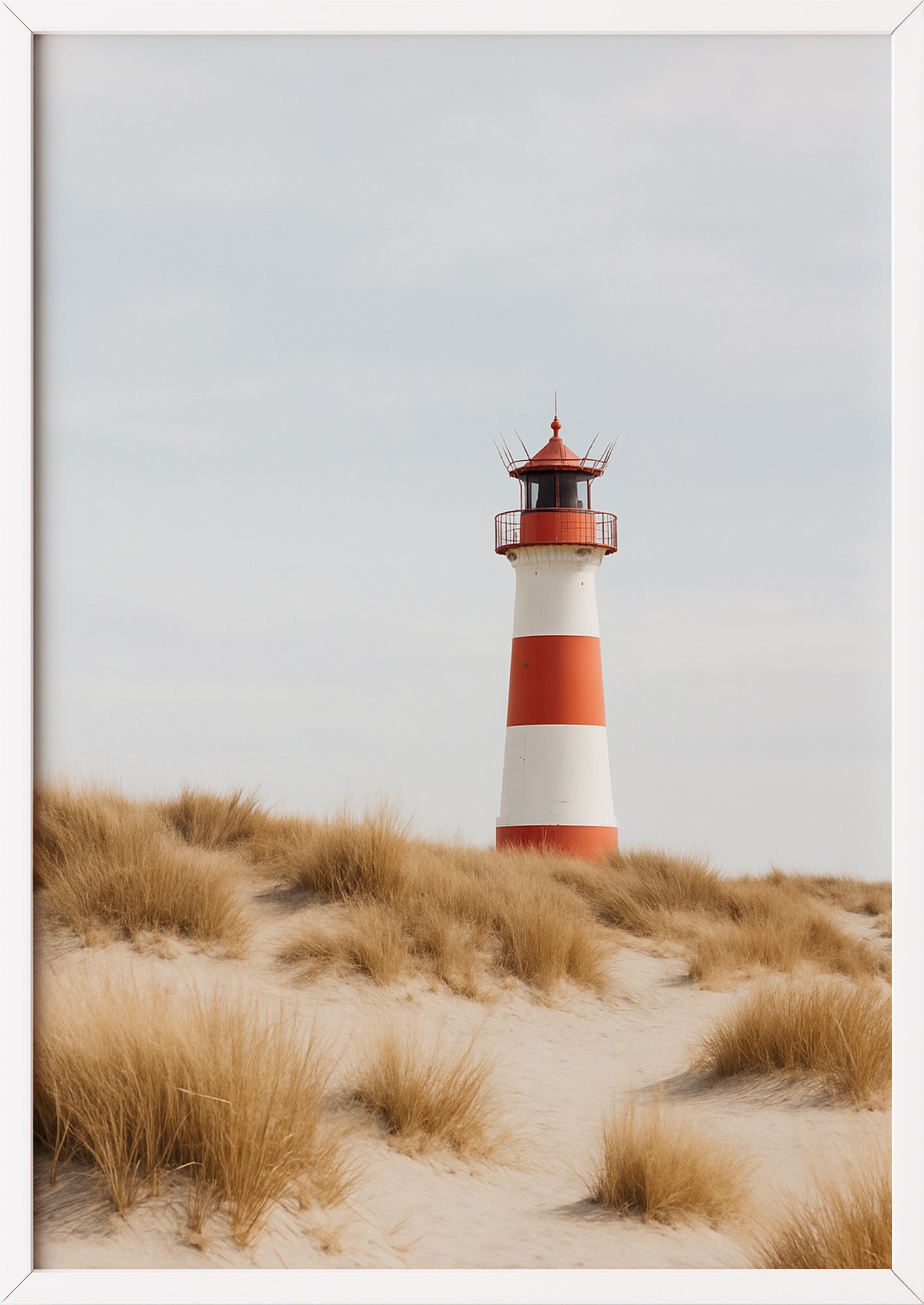 Aquarellähnlicher Leuchtturmdruck im weißen Rahmen vor neutraler Wand
