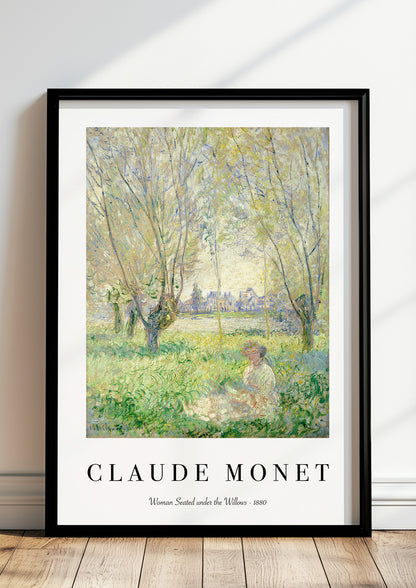Woman Seated under the Willows von Claude Monet als Poster, in schwarzem Rahmen, stehend auf dem Boden, angelehnt an einer Wand
