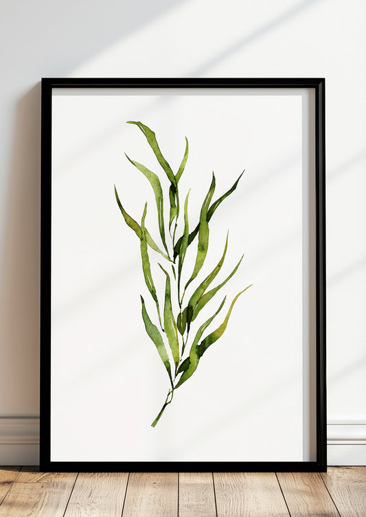 Gerahmtes Poster mit grünem Aquarellzweig lehnt auf dem Boden vor einer hellen Wand