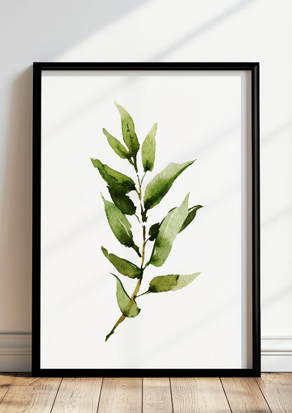 Gerahmtes Poster mit schmalblättrigem Zweig lehnt auf dem Boden vor einer hellen Wand