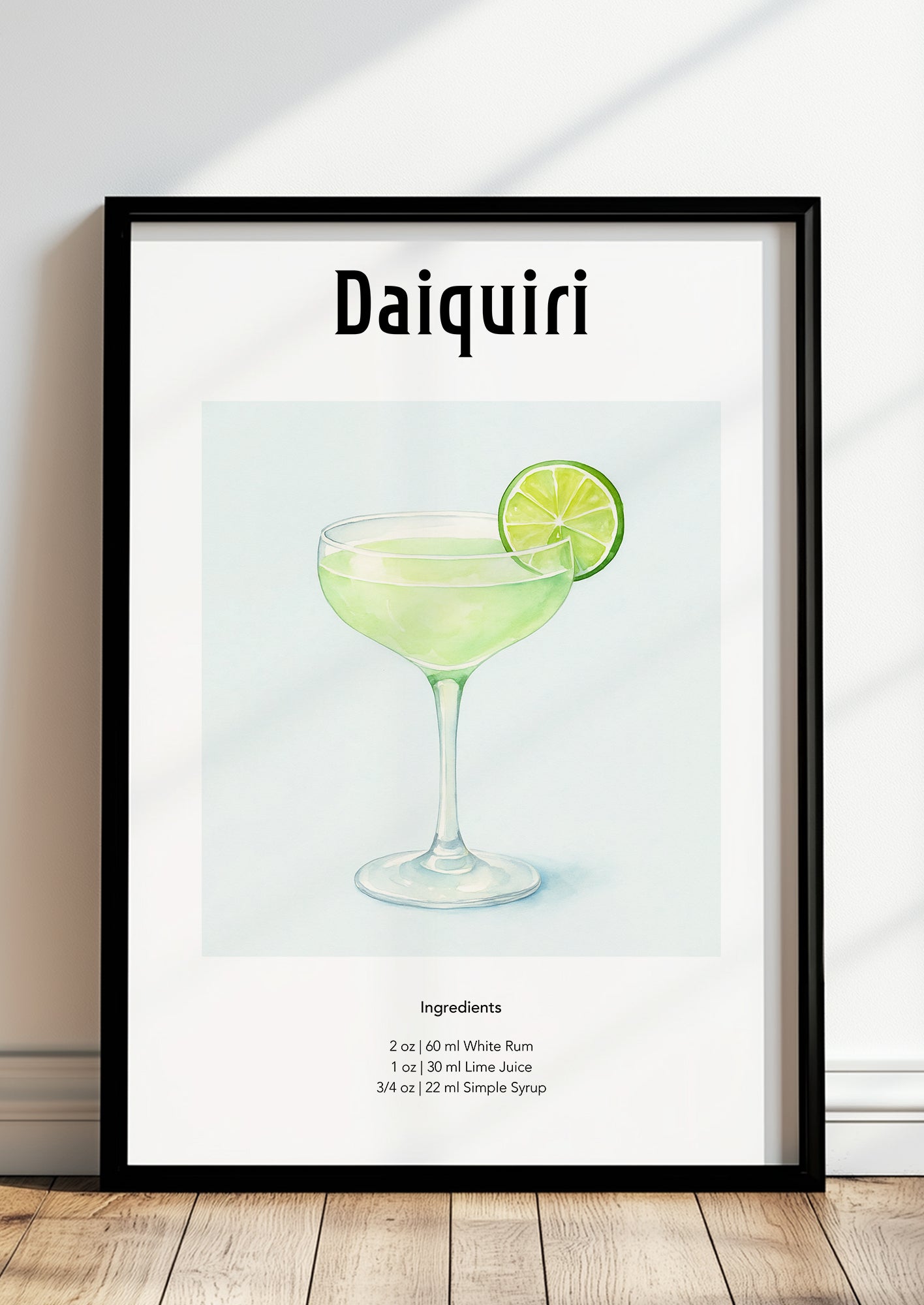 Gerahmtes Daiquiri-Poster lehnt auf dem Boden an einer hellen Wand