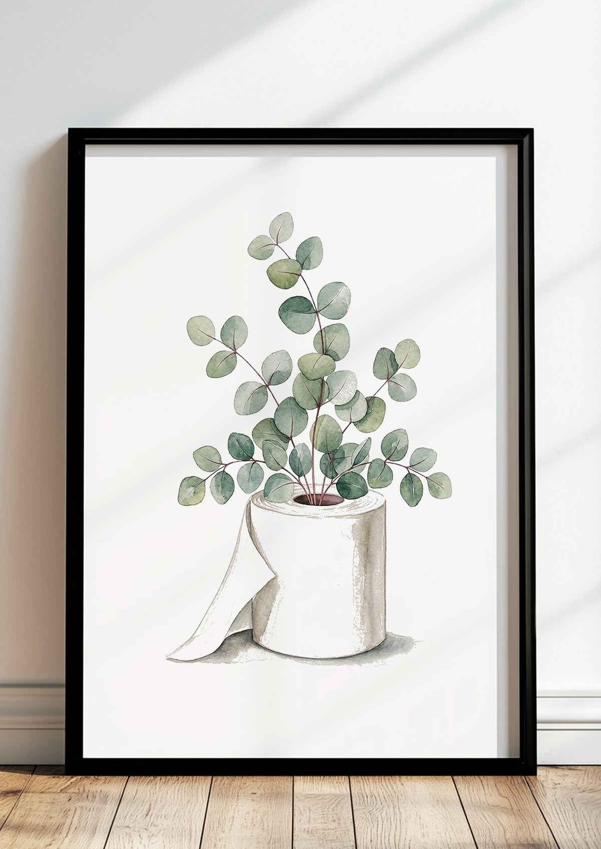 Aquarell Poster mit Eukalyptus in einer Klopapierrolle, im schwarzen Rahmen an eine helle Wand gelehnt