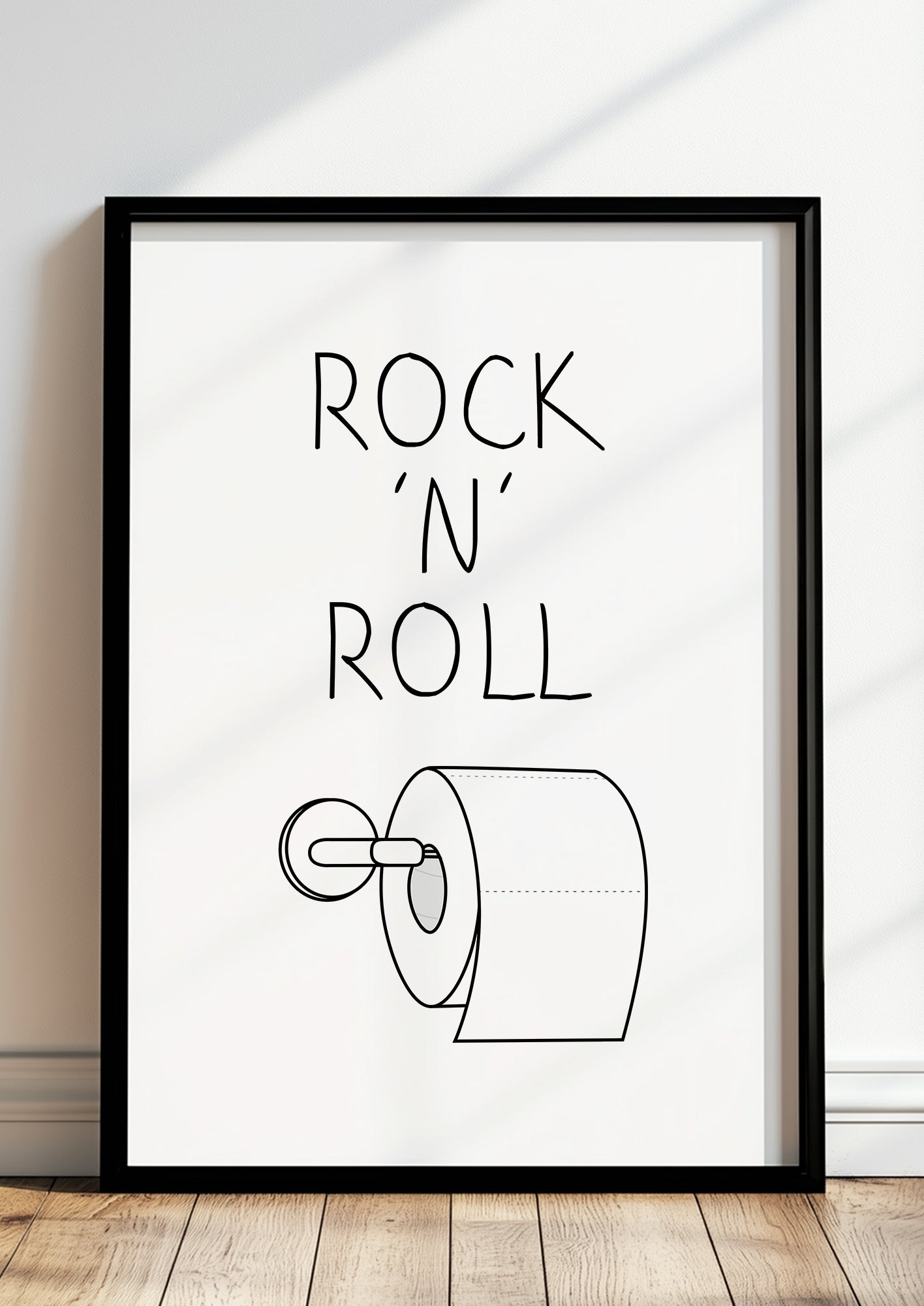 Gerahmtes Poster „Rock ‘N’ Roll“ in schwarzem Rahmen, inszeniert in moderner Wohnumgebung.