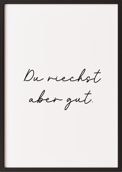 Hochformatiges Poster „Du riechst aber gut.“ mit schwarzem Rahmen, freigestellt.