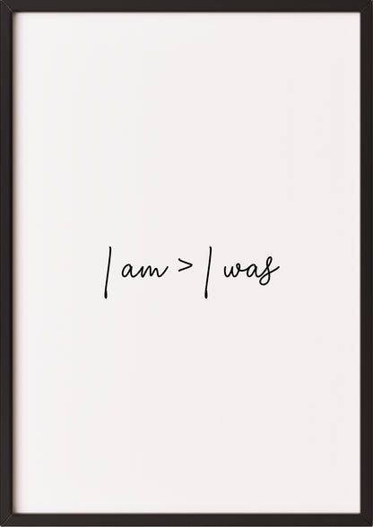Hochformatiges Poster „i am > i was“ mit schwarzem Rahmen.