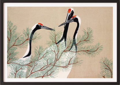 Eine Frau hängt Kamisaka Sekka – Cranes (from Momoyogusa) in schwarzem Rahmen an die Wand